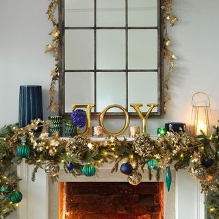 White mantelpiece with modern Christmas decorations