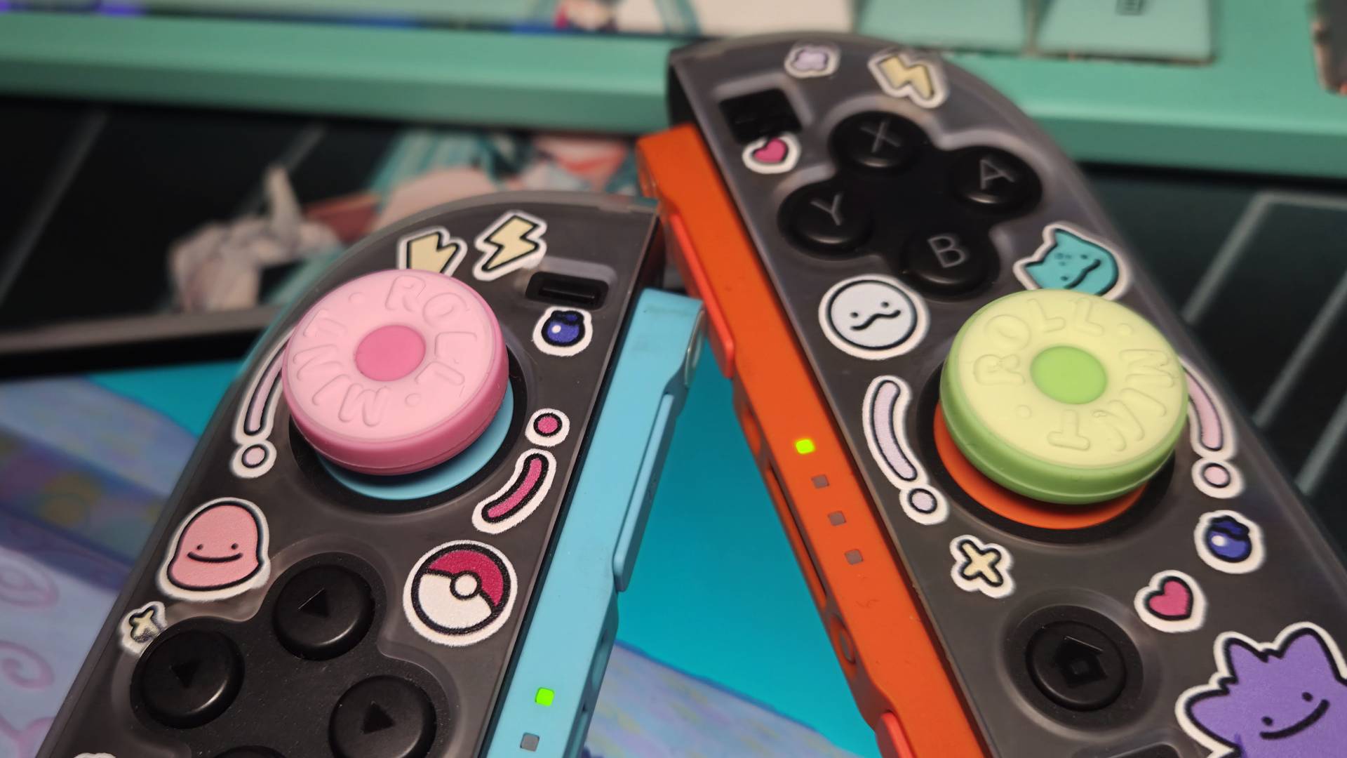 Photo of a pair of GeekShare grips on the sticks of a pair of Switch 2 Joy-Con controllers.