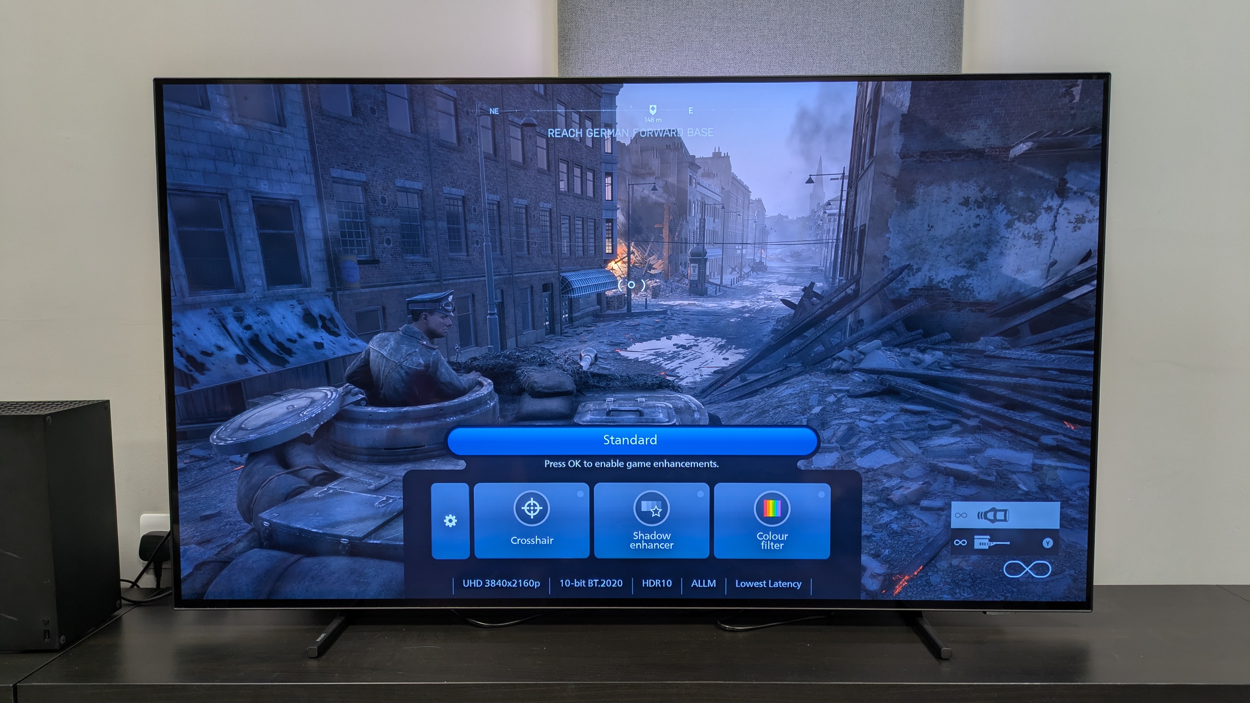 Philips OLED760 with a shot of Battlefield V and gaming menu on screen