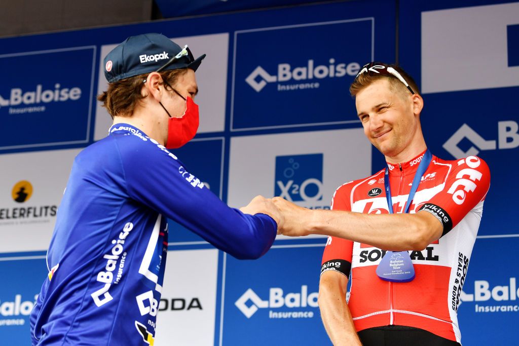 BERINGEN BELGIUM JUNE 19 LR Race winner Mauro Schmid of Switzerland and Team QuickStep Alpha Vinyl blue leader jersey and Tim Wellens of Belgium and Team Lotto Soudal second place celebrate winning the on the podium ceremony after the 91st Baloise Belgium Tour 2022 Stage 5 a 1799km stage from Gingelom to Beringen BaloiseBelgiumTour on June 19 2022 in Beringen Belgium Photo by Luc ClaessenGetty Images