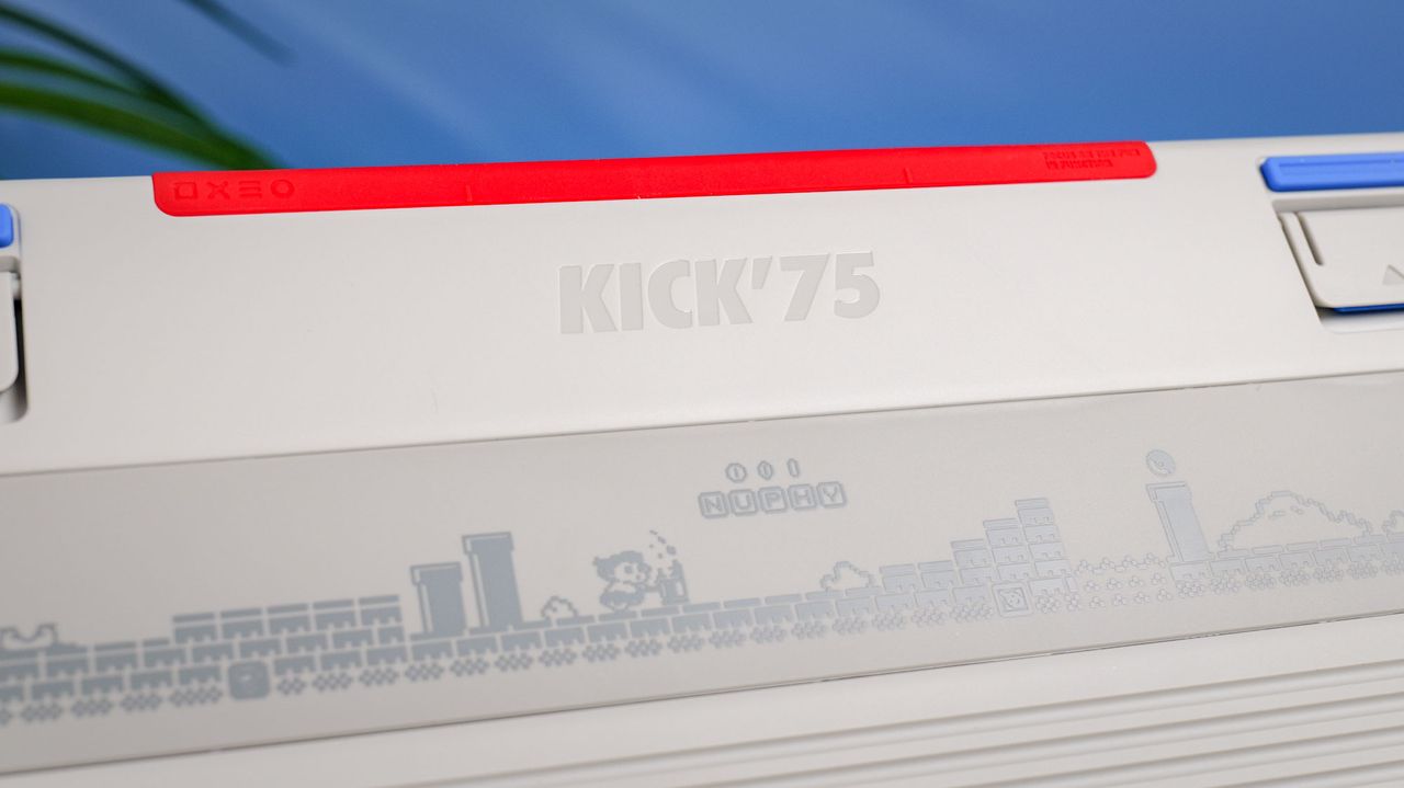 A close up shot of the rear of the NuPhy Kick75 with a blue wall in the background