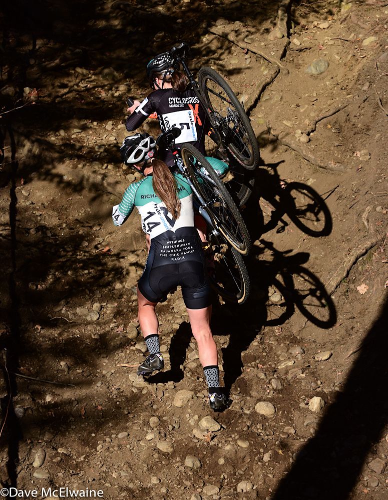 Britlee Bowman (House Industries) following Kathryn Cumming (Cyclocross Magazine) on the steep run-up
