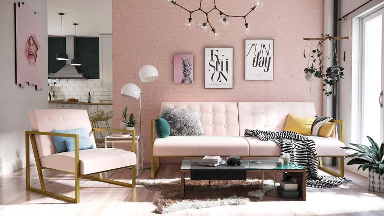 A small living room with pink microfiber couch and framed wall art by Wayfair