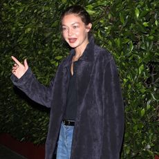 Gigi Hadid wears a navy suede jacket