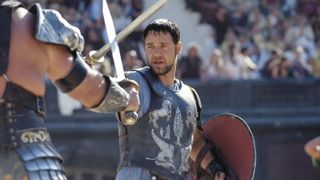 A still from the movie Gladiator, one of July's new Prime Video movies, in which Russell Crowe's character Maximus Decimus Meridius is in a sword fight with an adversary.