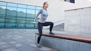 a photo of a woman doing a lateral step up outside