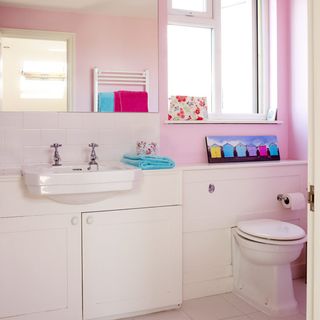 bathroom with wash basin and cabinet with commode
