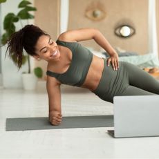 20 minute workouts at home: A woman doing a plank at home