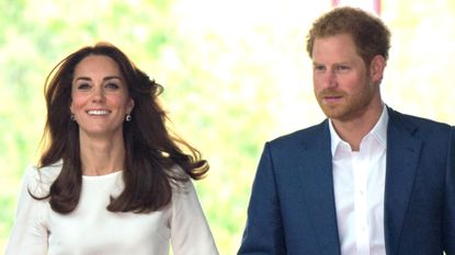 Kate Middleton, wearing a long-sleeved white top, smiles while walking with Prince Harry to launch the Heads Together Campaign on May 16, 2016