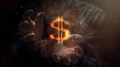 man with hands cupping dollar bill sign that's on fire