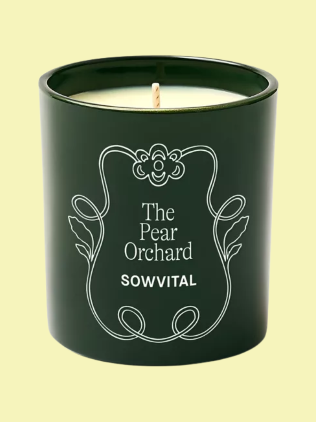 A green scented candle from SOWVITAL with pear and green apple accords