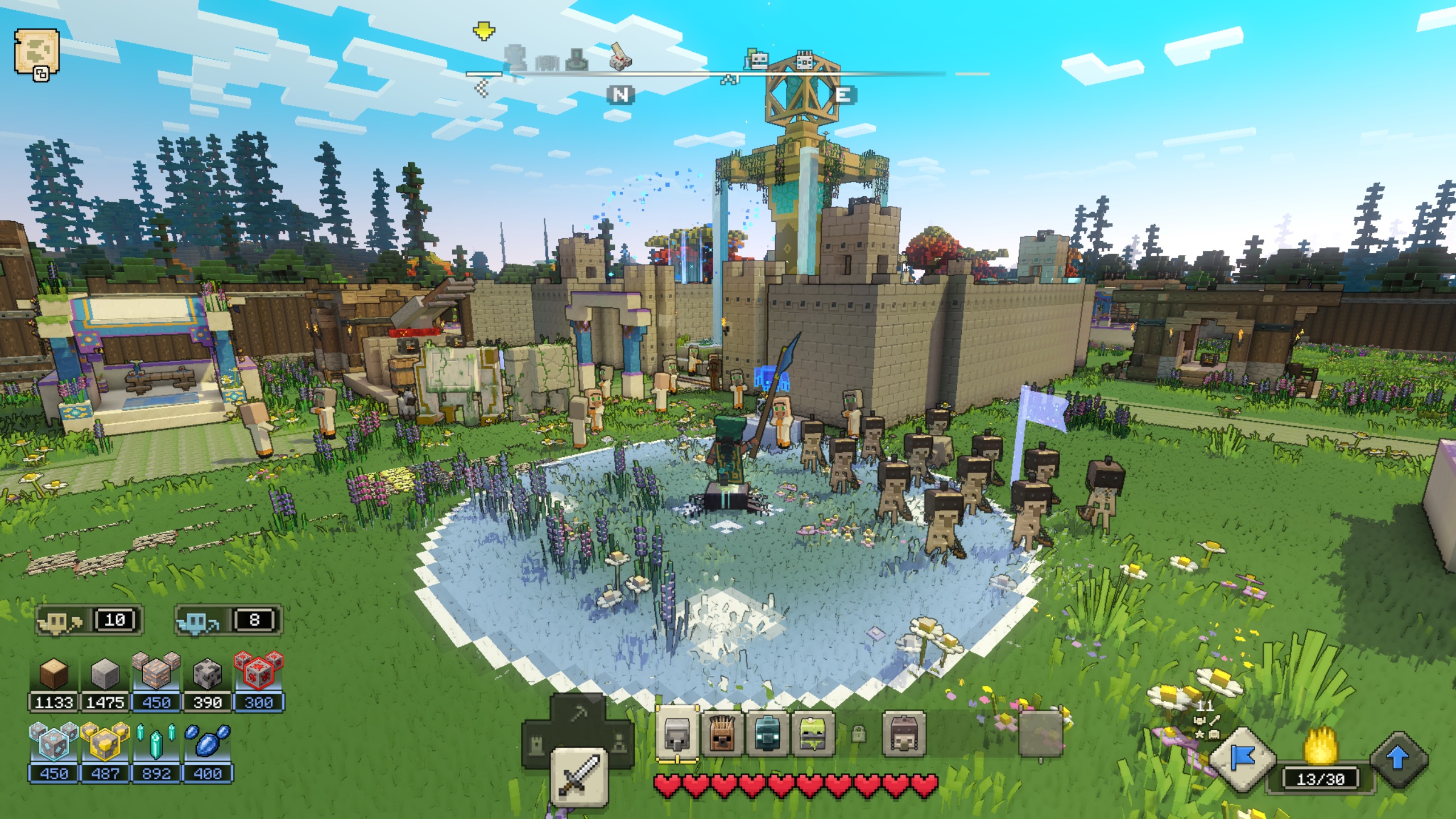 Minecraft Legends - A player stands inside a small village waving a blue command flag to summon a group of skeletons