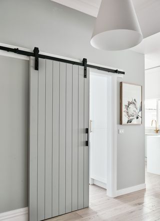 Grey sliding door in hallway idea by Norsu Interiors
