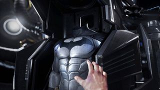 En hand som sträcker sig mot en Batman-dräkt i Batman: Arkham VR