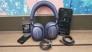 Bowers & Wilkins Px7 S3 on a deck, in the middle of a Google phone, a Hidisz DAP, and Questyle DAC