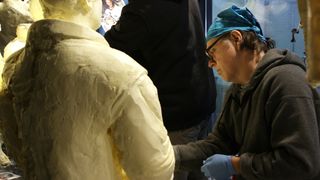 Paul Brooke, one of the lead sculptors for the American Dairy Association Mideast's annual butter display, works on smoothing butter on the 2019 exhibtion honoring the 50th anniversary of Apollo 11.