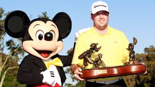 Robert Garrigus poses with the trophy after winning the Children's Miracle Network Classic at the Disney Magnolia course on November 14, 2010