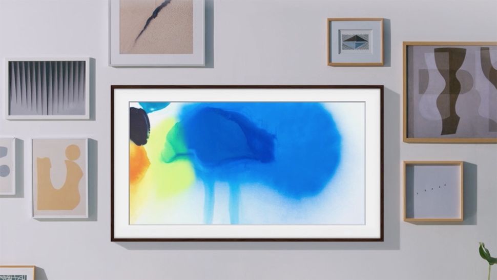 A press shot of the Samsung Frame TV, on a wall with other frames.