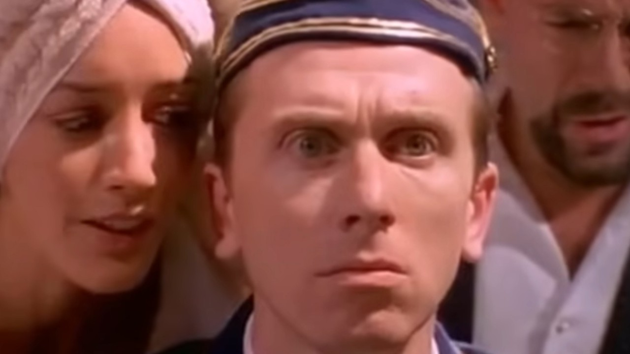 Tim Roth receiving whispers in his ear in Four Rooms