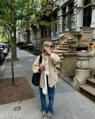 Woman wearing a barn jacket and jeans in NYC.