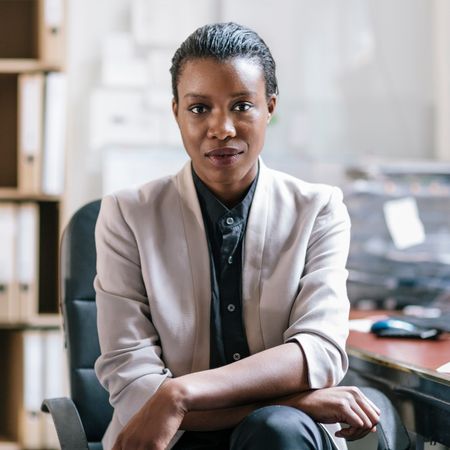 A woman sitting at a desk in an office.