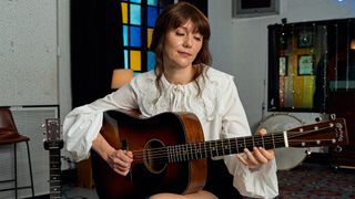 A photo of Molly Tuttle with the Martin D-18 Molly Tuttle