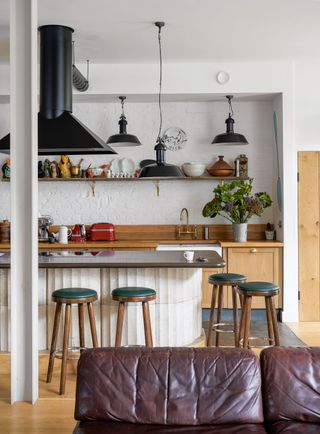 an industrial style kitchen with wooden cabinets