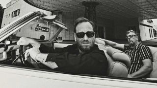 The Black Keys posing in a convertable car