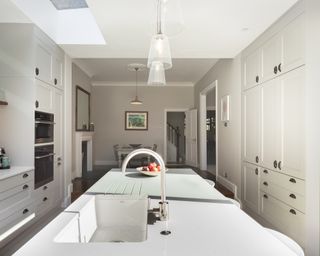 grey kitchen in extension with island and view to dining room