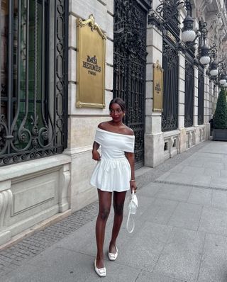 Influencer styles a white mini skirt.