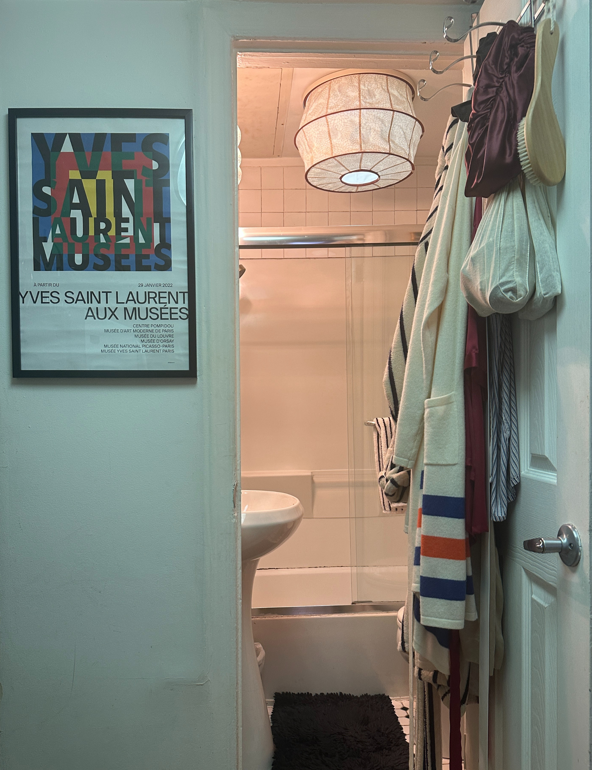 Gem Tuberose light cover by Tulip Shades styled in an NYC bathroom with subway tiles