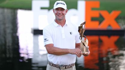 ucas Glover of the United States poses with the trophy after putting in to win during the first playoff hole on the 18th green to win the tournament during the final round of the FedEx St. Jude Championship