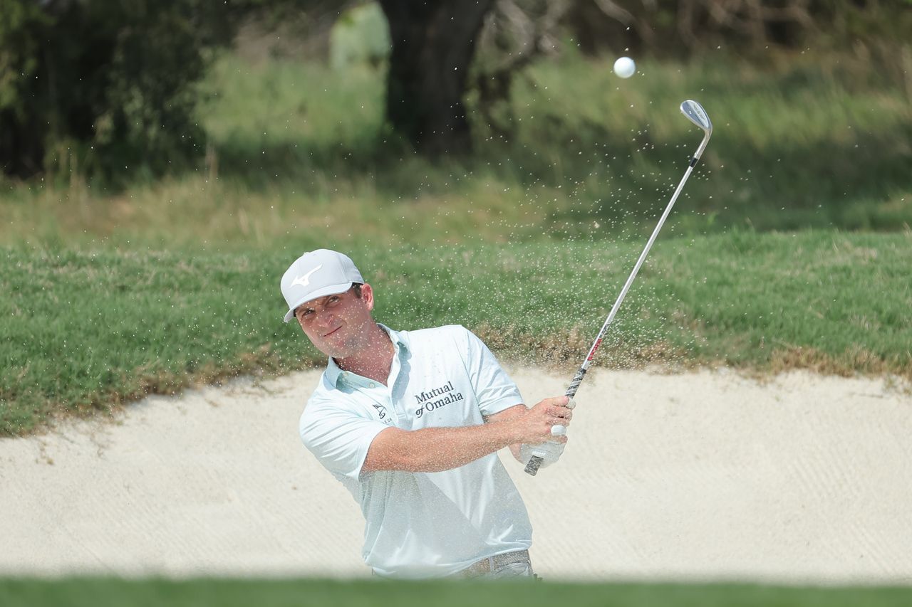 Steven Fisk hits a wedge shot out of the bunker