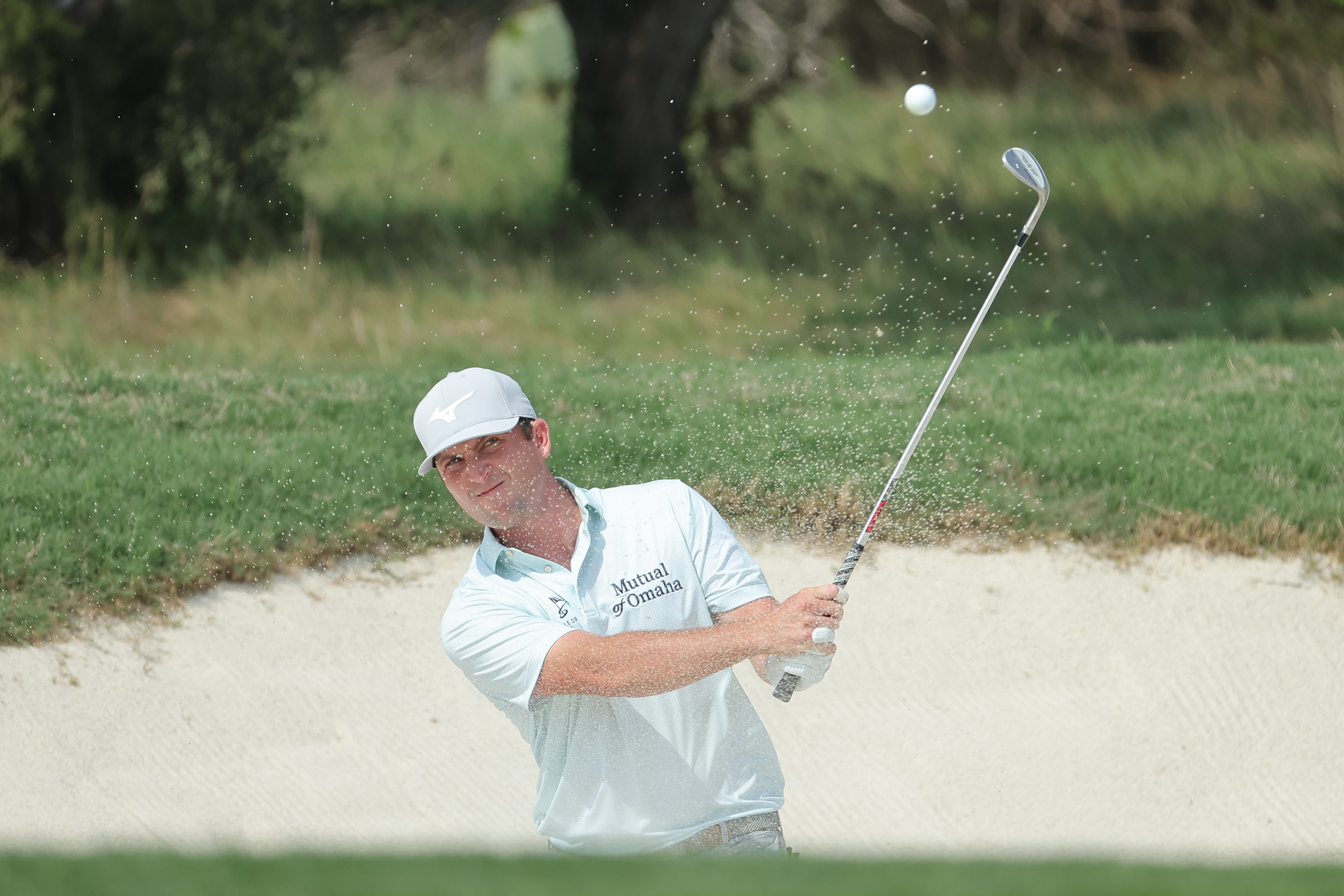 Steven Fisk hits a wedge shot out of the bunker
