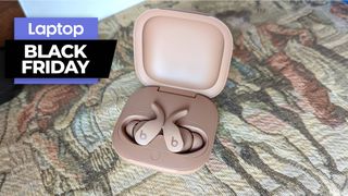 Kim Kardashian Beats Fit Pro earbuds on a flower blanket