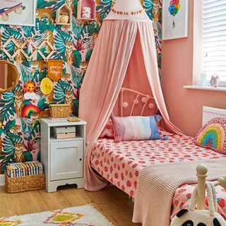 girls bedroom with floral wallpaper and canopy