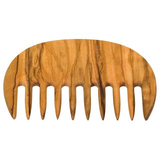 An olive wood afro comb stands against a white background.