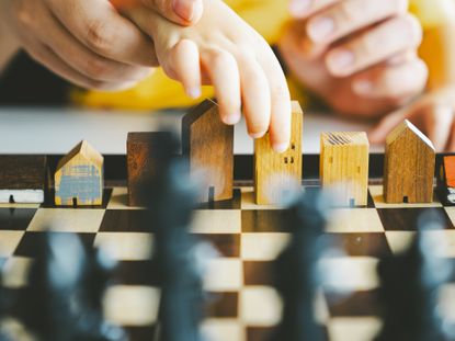 Hands holding a house model