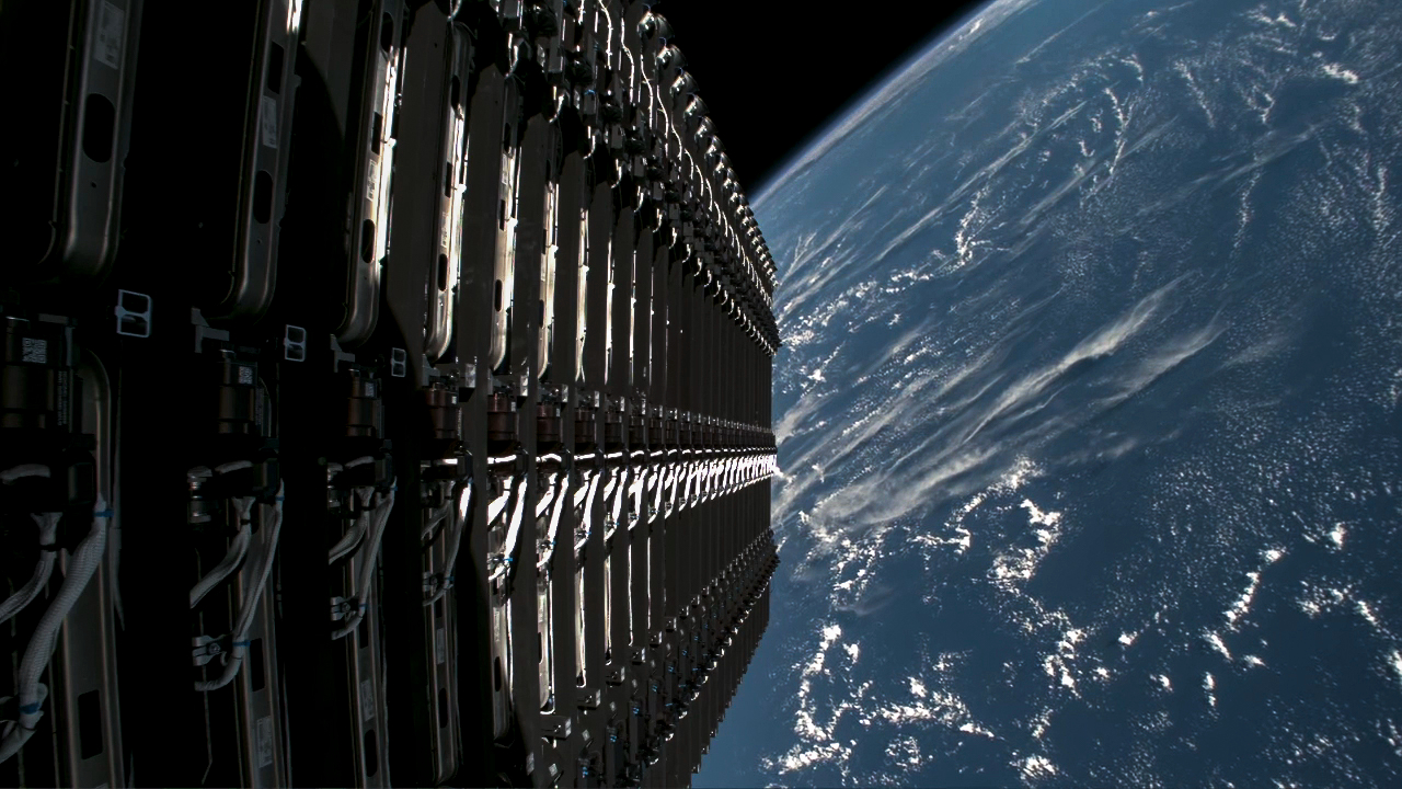 View from the upper stage off a Falcon 9 rocket, showing a stack of 28 satellites with earth in the background