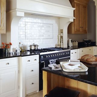 kitchen area with white cabinets and black gas top