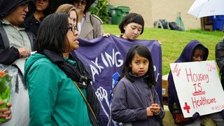 Martha Escudero, 42, with daughter Victoria Escudero, 10, speaks at a rally with local housing and advocacy groups ahead of moving into the vacant home