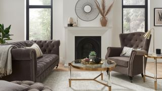 neutral living room with brown chesterfield sofa and large fireaplace