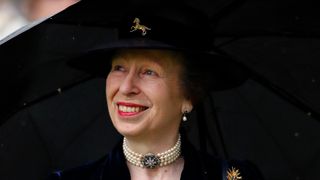 Princess Anne, Princess Royal shelters under an umbrella as she attends day two of Royal Ascot at Ascot Racecourse on June 19, 2019 in Ascot, England.