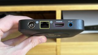 Sky Stream box held in a hand showing its ports