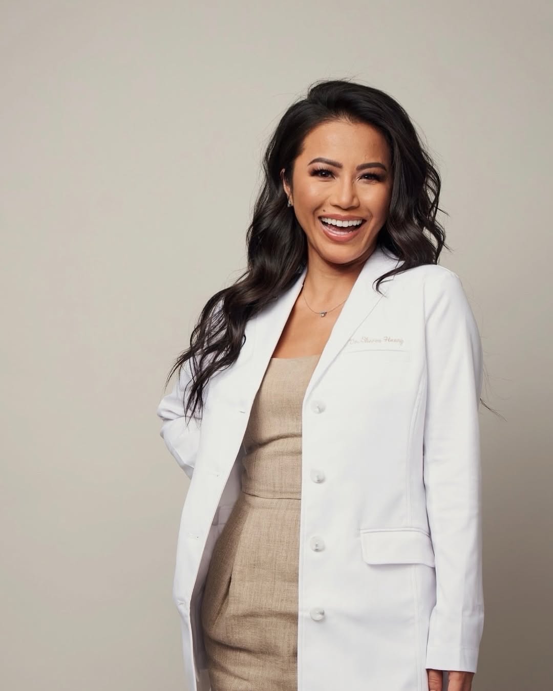 Sharon Huang in a white lab coat