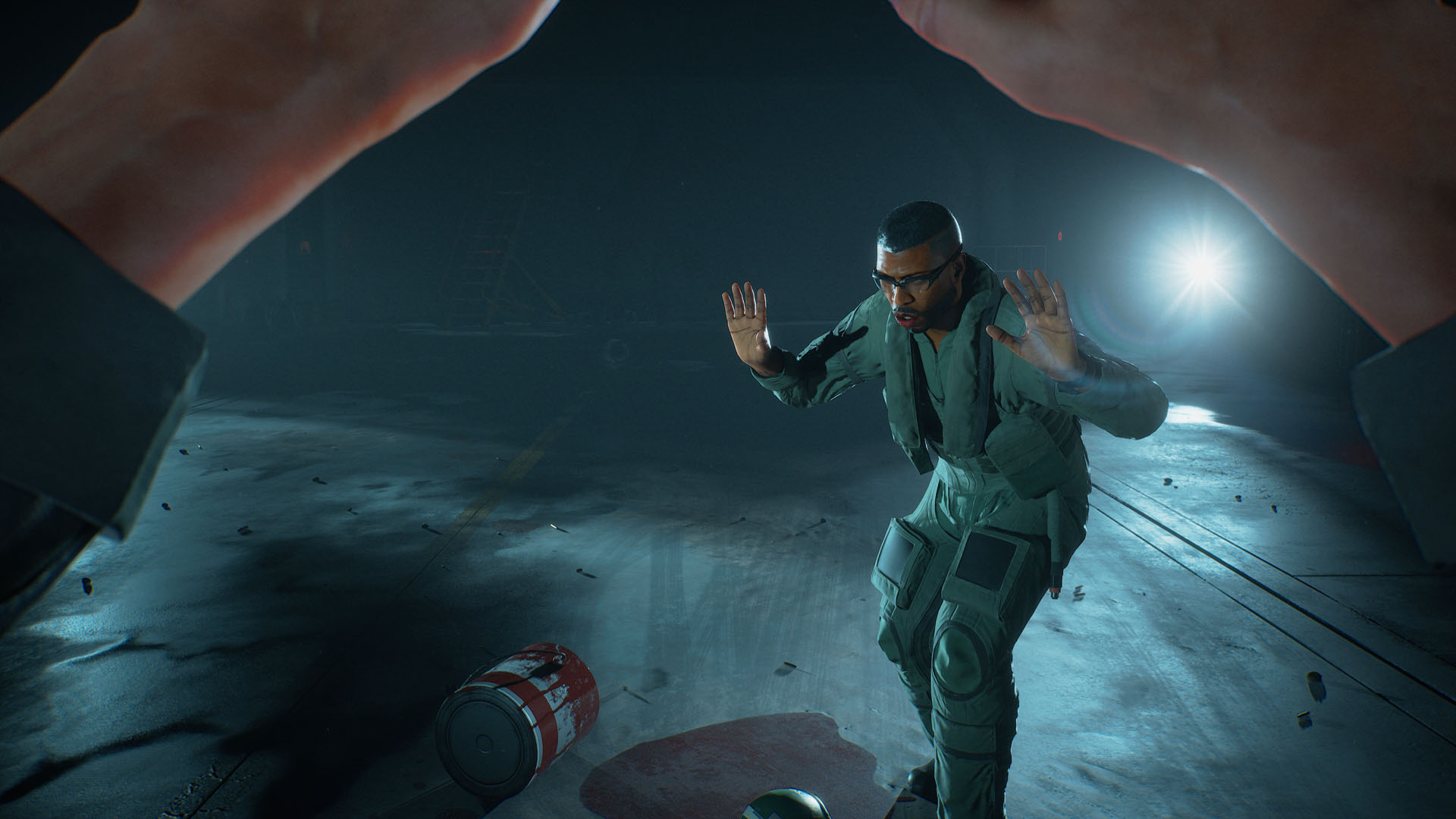 Professor Baxter stands with his hands up in a dark environment in Ace Combat 8: Wings of Theve