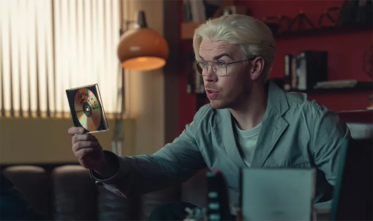 Will Poulter holding a CD ROM