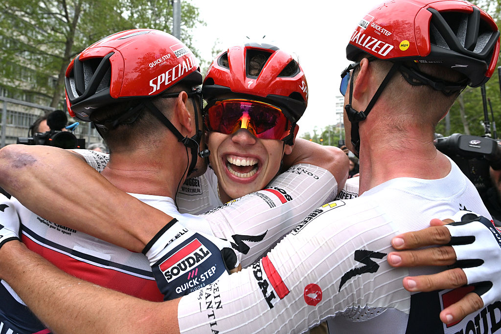 A smiling Magnier embraces his teammates after winning