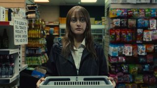 Ella Purnell, pictured in a convenience store wearing drab clothing, stars as Rhiannon Lewis in dark comedy TV show &quot;Sweetpea&quot; season 1