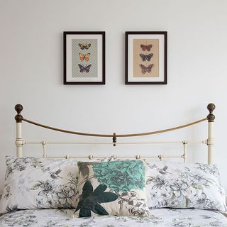 bedroom with white wall and butterfly art